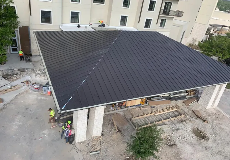 Metal roofing installation team working on a commercial building in Chatham